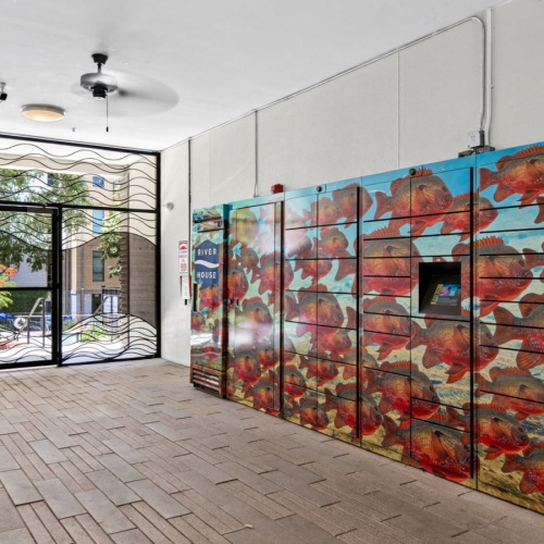 a room with a wall of paintings