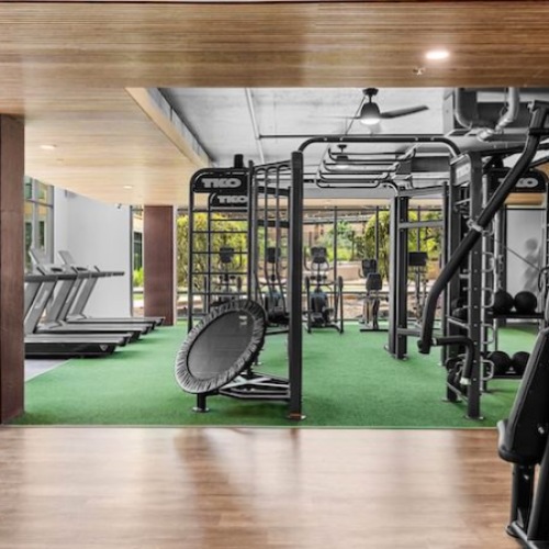 Luxury fitness center with turf training area and strength equipment at River House luxury apartments on the San Antonio River Walk
