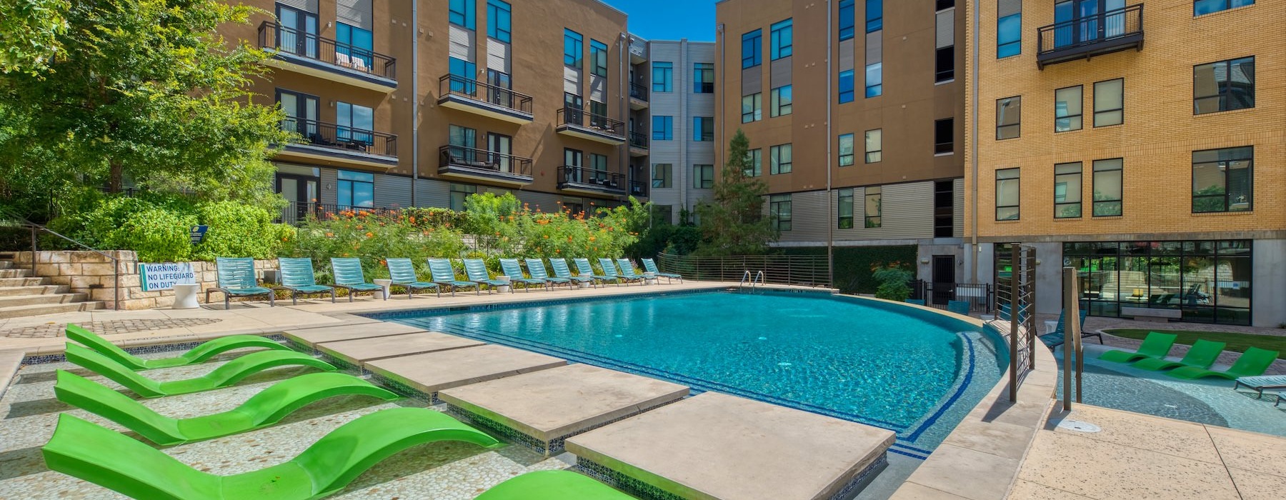a swimming pool in a courtyard between buildings